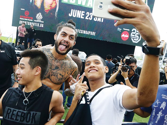 Tyson Pedro getting a selfie with a fan during the open workout at ocbc square